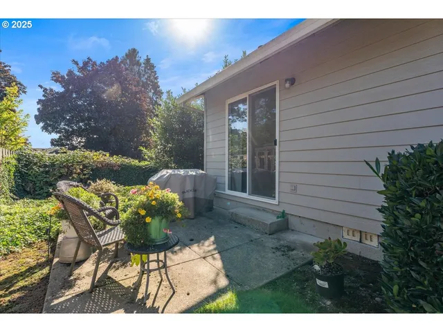 a backyard of a house with table and chairs