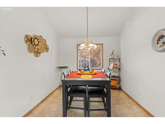 a dining room with a table and chairs