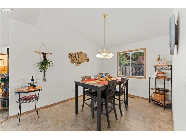 a view of a dining room with furniture and window