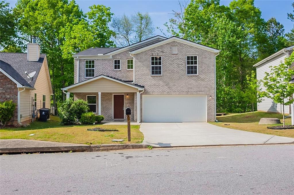a front view of a house with a yard