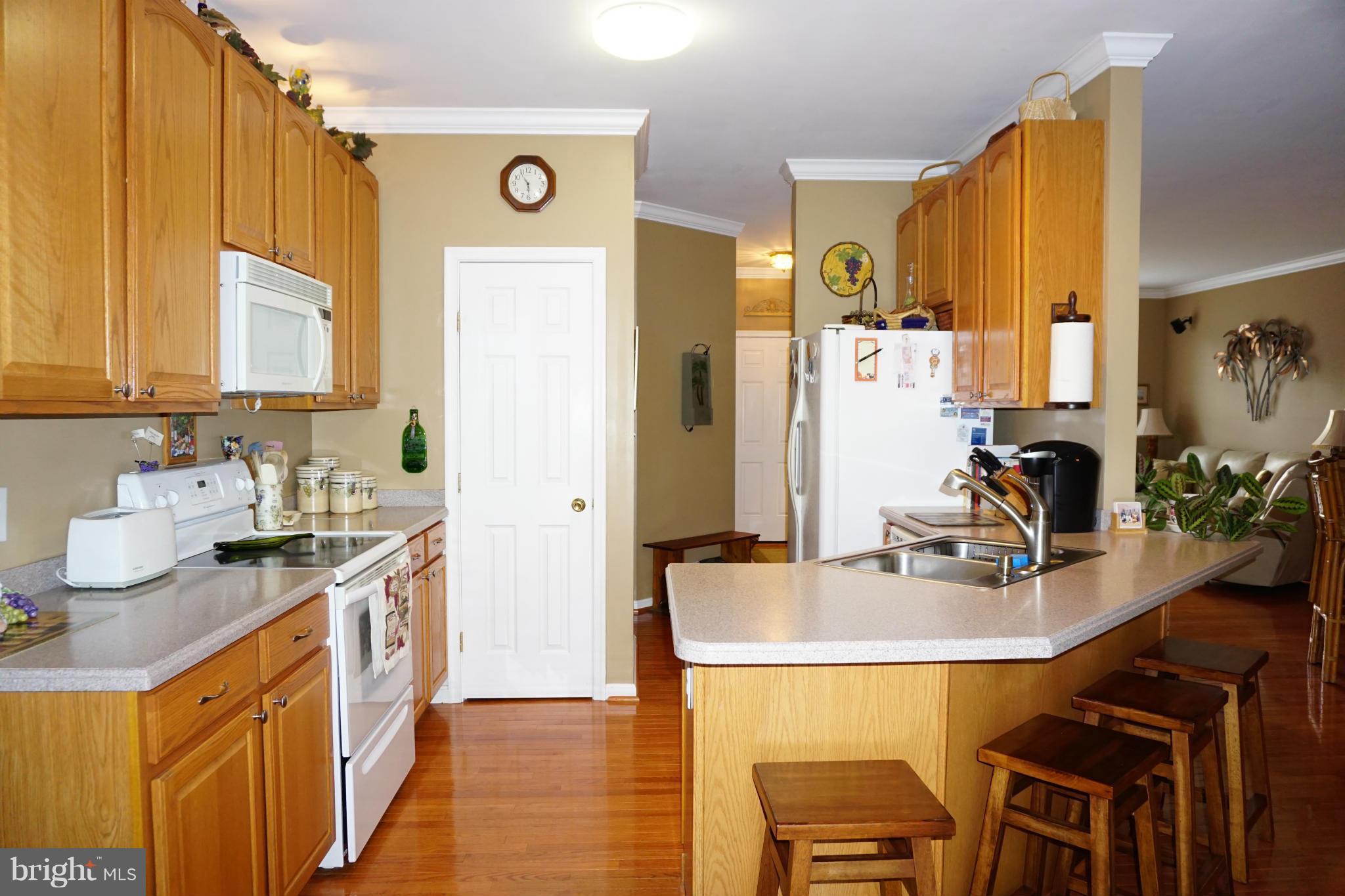 11202 Rawhide Road Lusby, MD 20657 - Photo 7 of 24 a kitchen with stainless steel appliances a sink a stove and a refrigerator