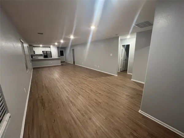 a view of a electric room and wooden floor