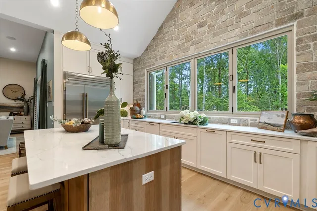 a kitchen with a sink and large window