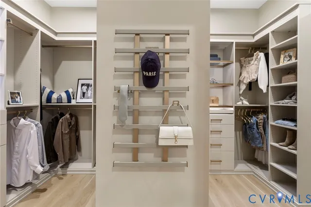 a view of walk in closet and bedroom