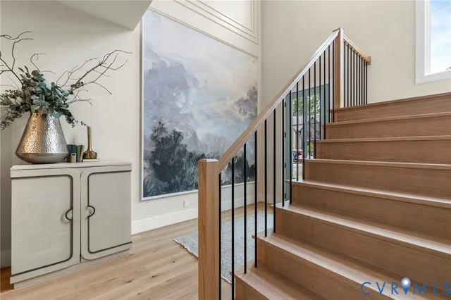 a view of staircase with wooden floor and a potted plant
