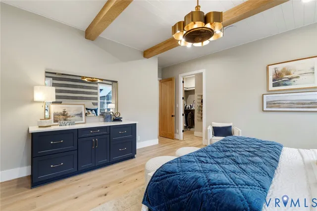 a spacious bedroom with a bed and a dresser