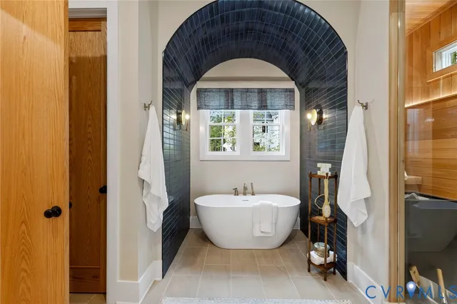 a spacious bathroom with a bathtub and a window