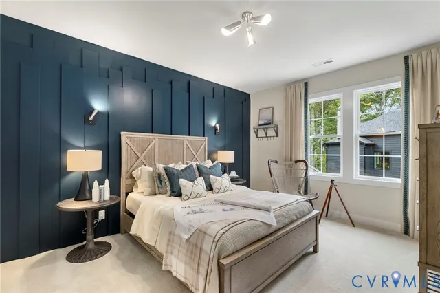 a bedroom with a bed lamps and a large mirror