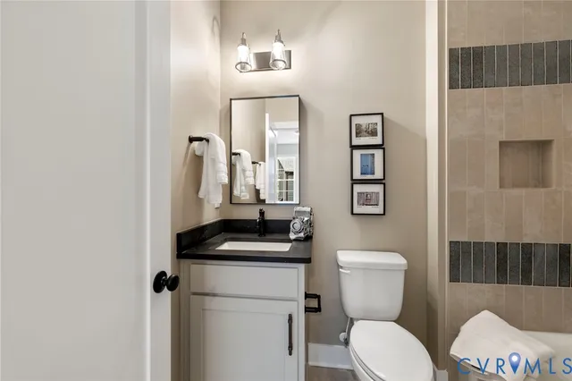 a bathroom with a toilet a sink and mirror