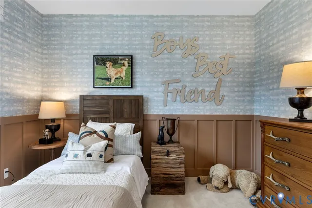 a bedroom with a bed and a lamp on dresser