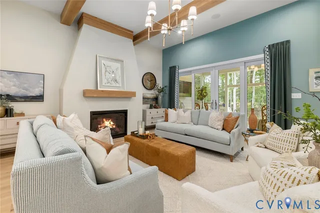 a living room with furniture a large window and a fireplace