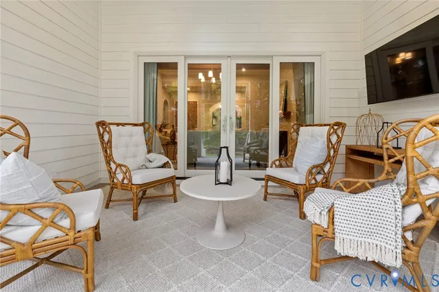 a outdoor living space with patio furniture and a flat screen tv