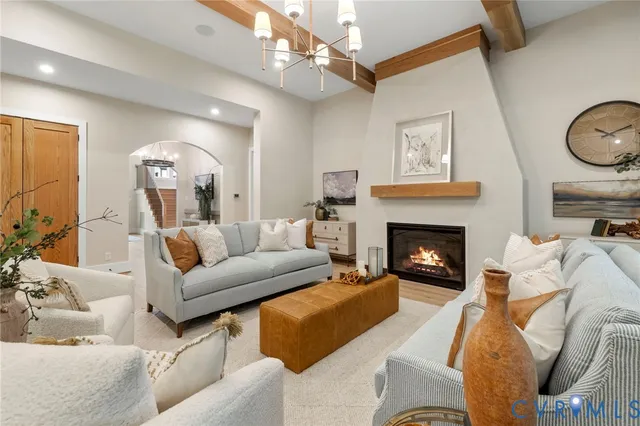 a living room with furniture a mirror and a fireplace