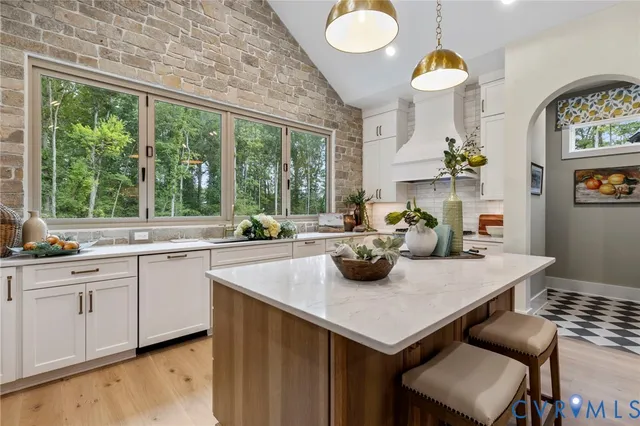 a kitchen with a table chairs and window
