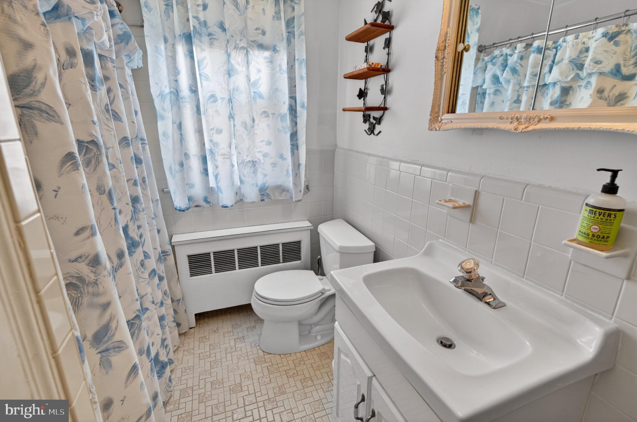 2006 Vista Street Philadelphia, PA 19152 - Photo 12 of 18 a white toilet sitting next to a bathroom sink