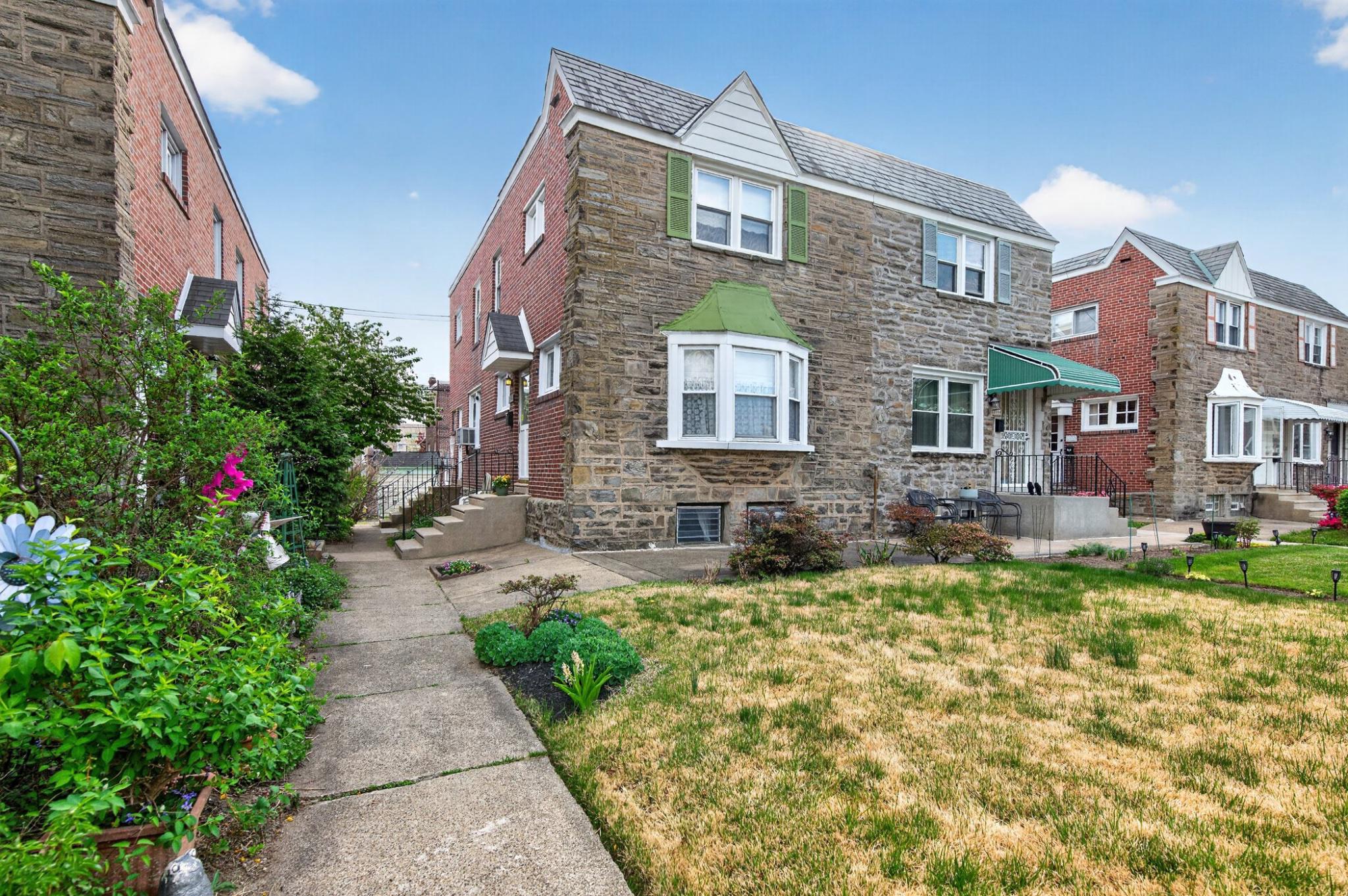2006 Vista Street Philadelphia, PA 19152 - Photo 2 of 18 a view of a brick building next to a yard
