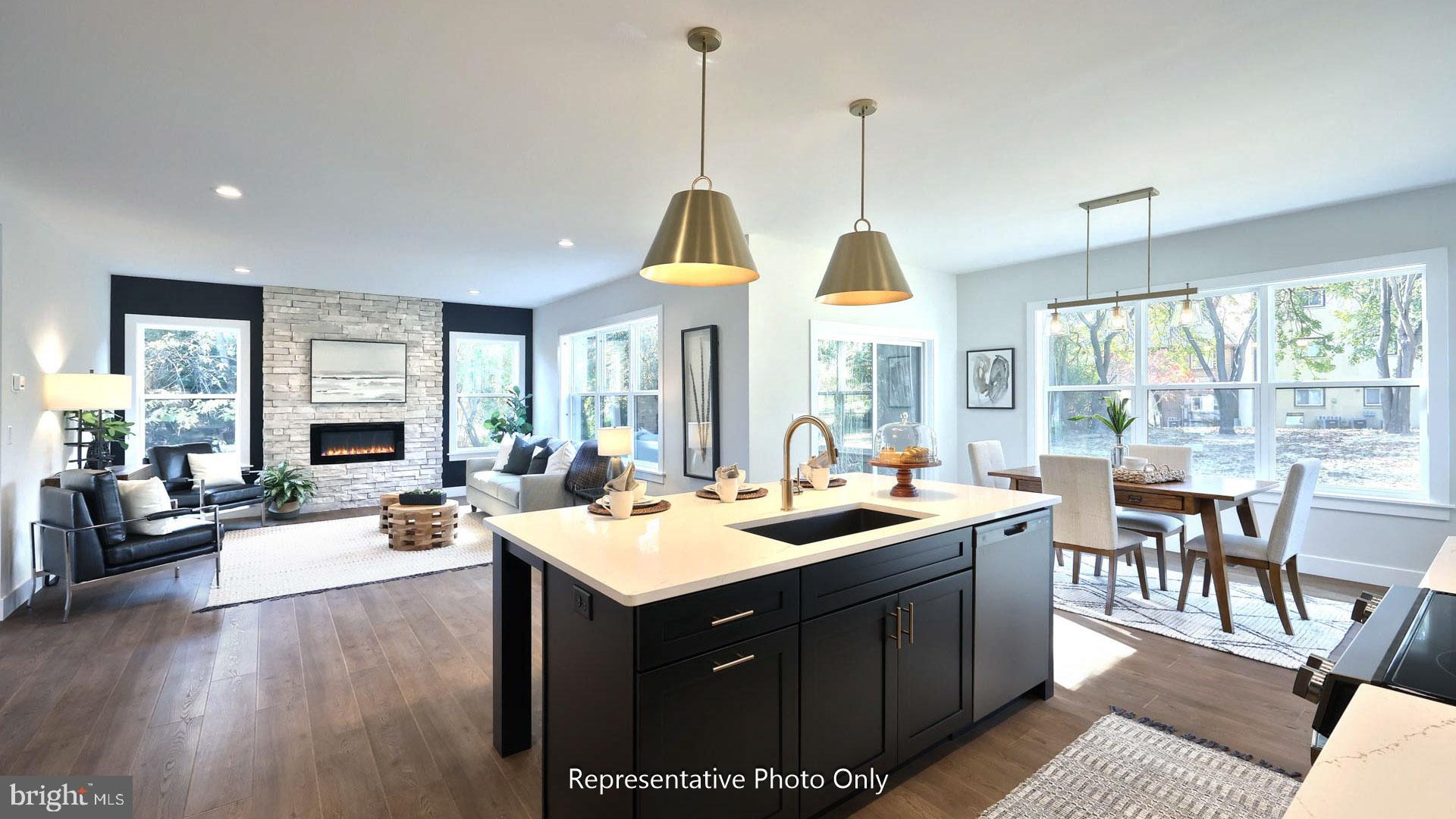 80 Tupelo Street Lititz, PA 17543 - Photo 7 of 22 a view of a dining room and livingroom with furniture wooden floor a rug a fireplace
