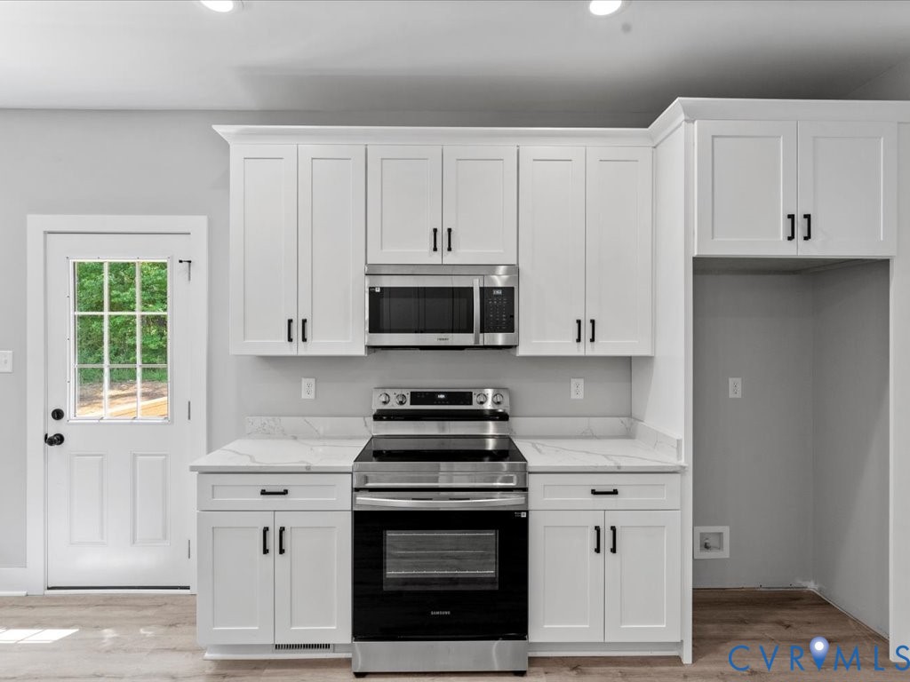 517 Frenchs Store Road Cumberland, VA 23040 - Photo 12 of 22 a kitchen with white cabinets and appliances