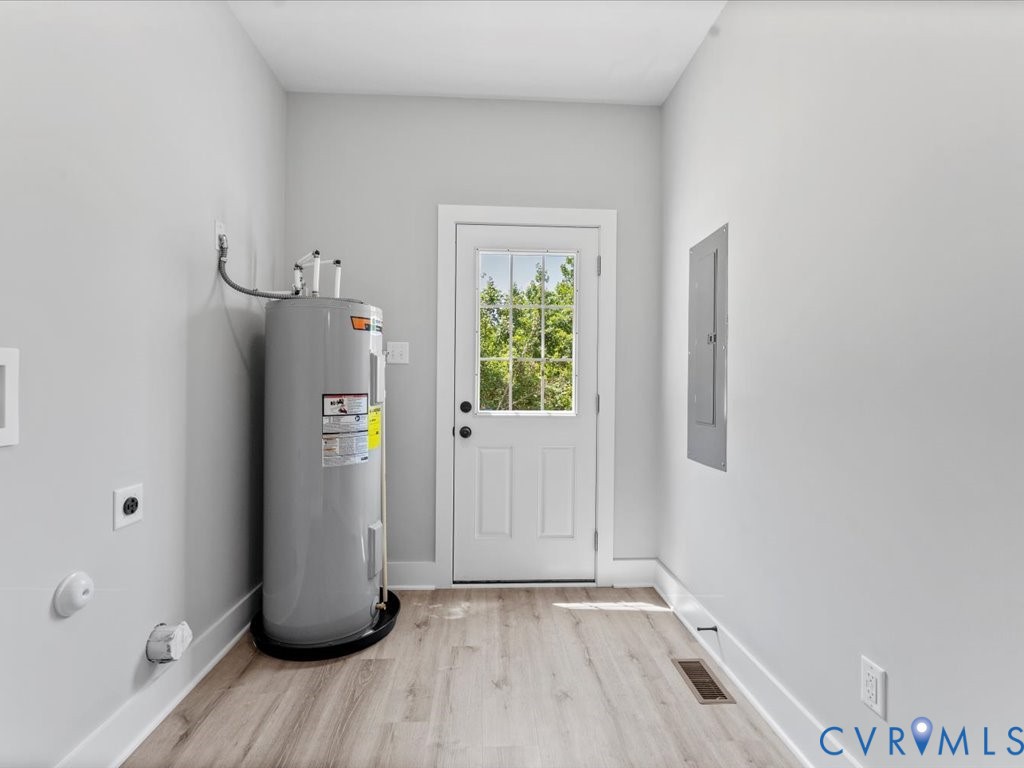 517 Frenchs Store Road Cumberland, VA 23040 - Photo 16 of 22 a view of an empty room with wooden floor and a window
