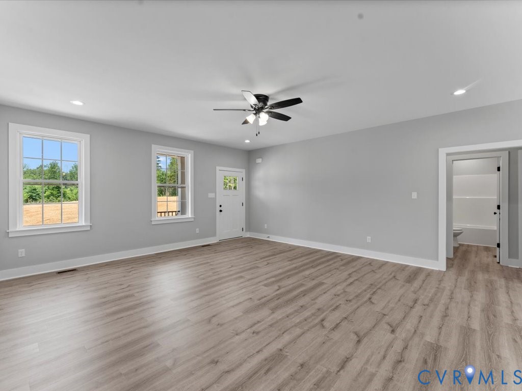 517 Frenchs Store Road Cumberland, VA 23040 - Photo 6 of 22 an empty room with wooden floor and windows