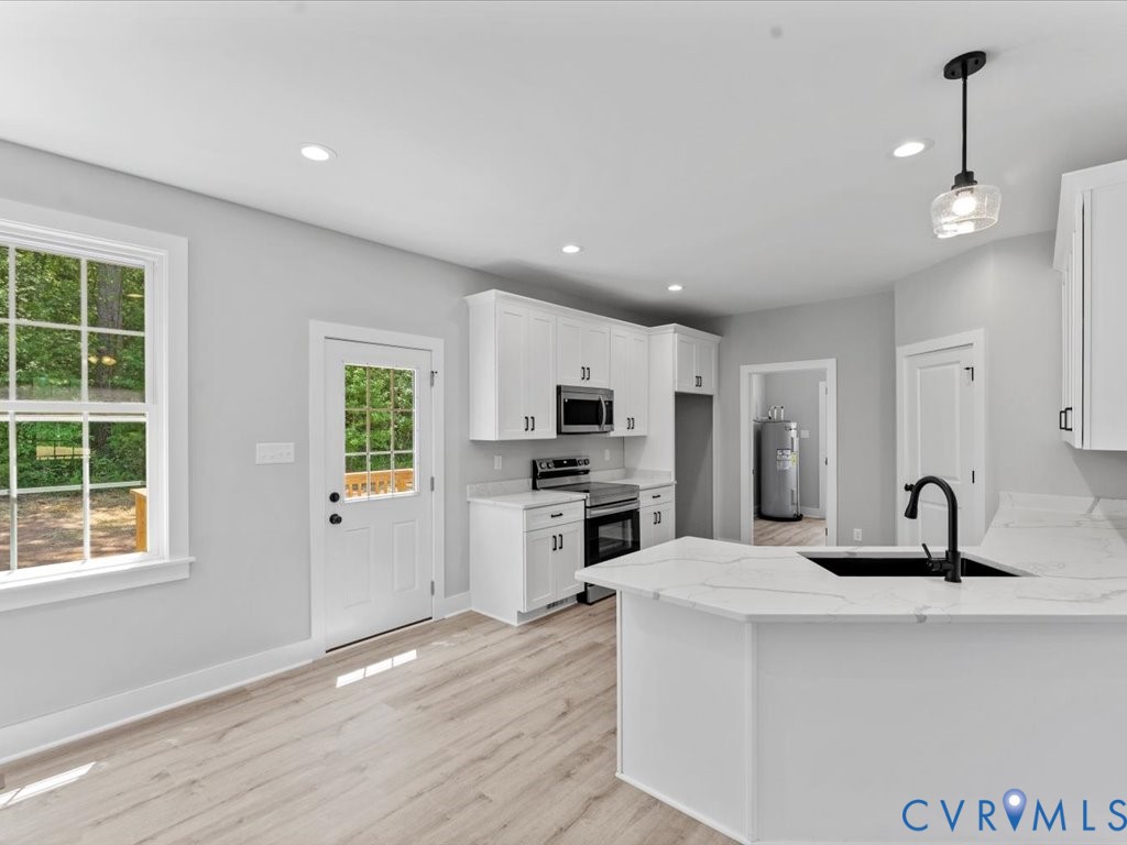 517 Frenchs Store Road Cumberland, VA 23040 - Photo 8 of 22 a kitchen with kitchen island a sink stainless steel appliances and window