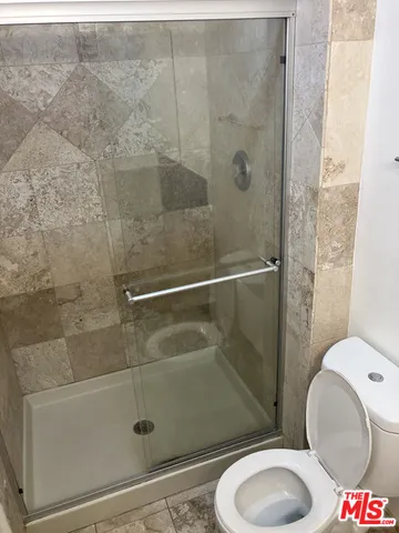a bathroom with a toilet and a shower