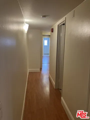 a view of hallway with wooden floor