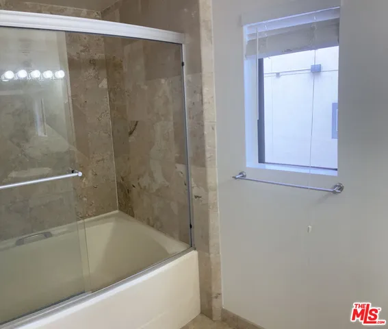 a bathroom with a shower and a sink