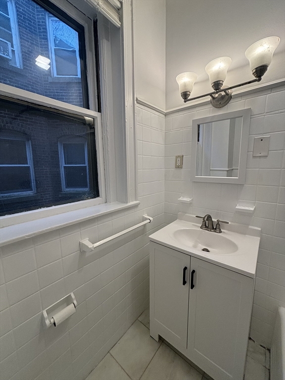 6 Beals Street, Unit 2 Brookline, MA 02446 - Photo 6 of 9 a bathroom with a sink and a mirror