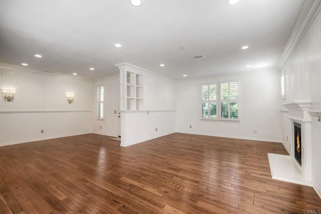 4302 Pacifica Way, Unit 2 Oceanside, NY 11572 - Photo 12 of 51 an empty room with wooden floor and windows