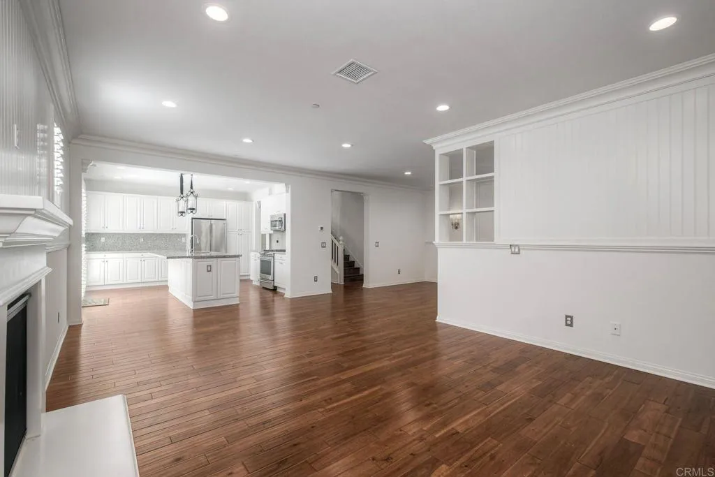4302 Pacifica Way, Unit 2 Oceanside, NY 11572 - Photo 18 of 51 a view of empty room with wooden floor and fireplace