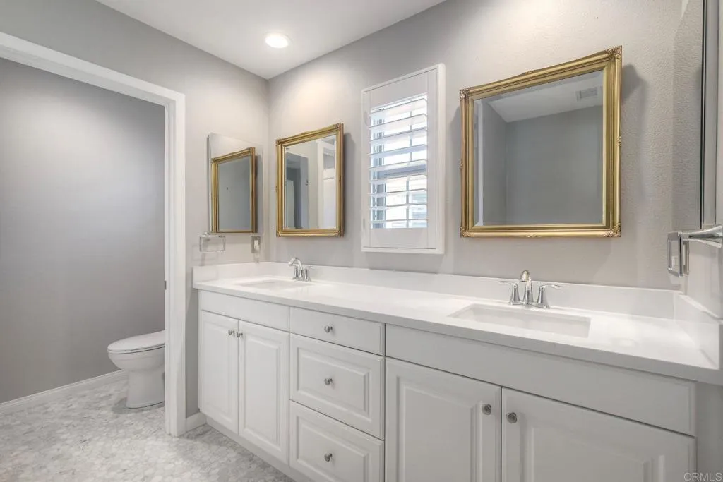 4302 Pacifica Way, Unit 2 Oceanside, NY 11572 - Photo 26 of 51 a bathroom with 2 sink and a mirror