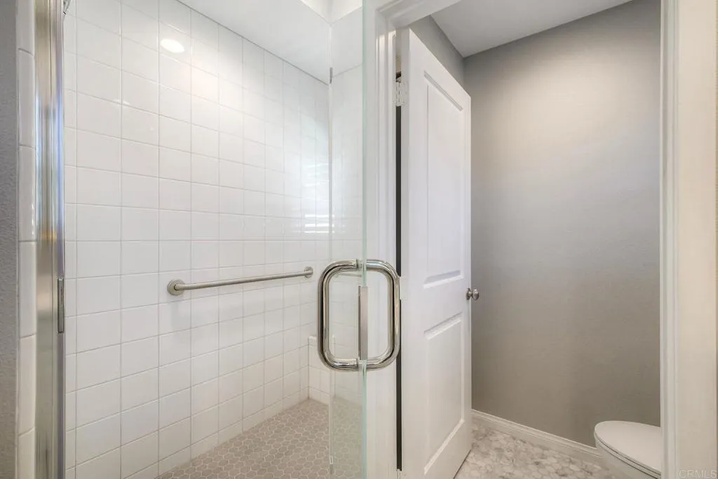 4302 Pacifica Way, Unit 2 Oceanside, NY 11572 - Photo 27 of 51 a bathroom with a glass shower door
