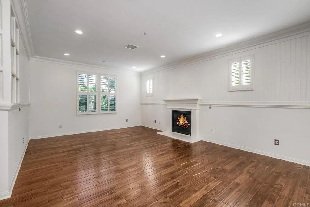 4302 Pacifica Way, Unit 2 Oceanside, NY 11572 - Photo 7 of 51 an empty room with windows and fireplace