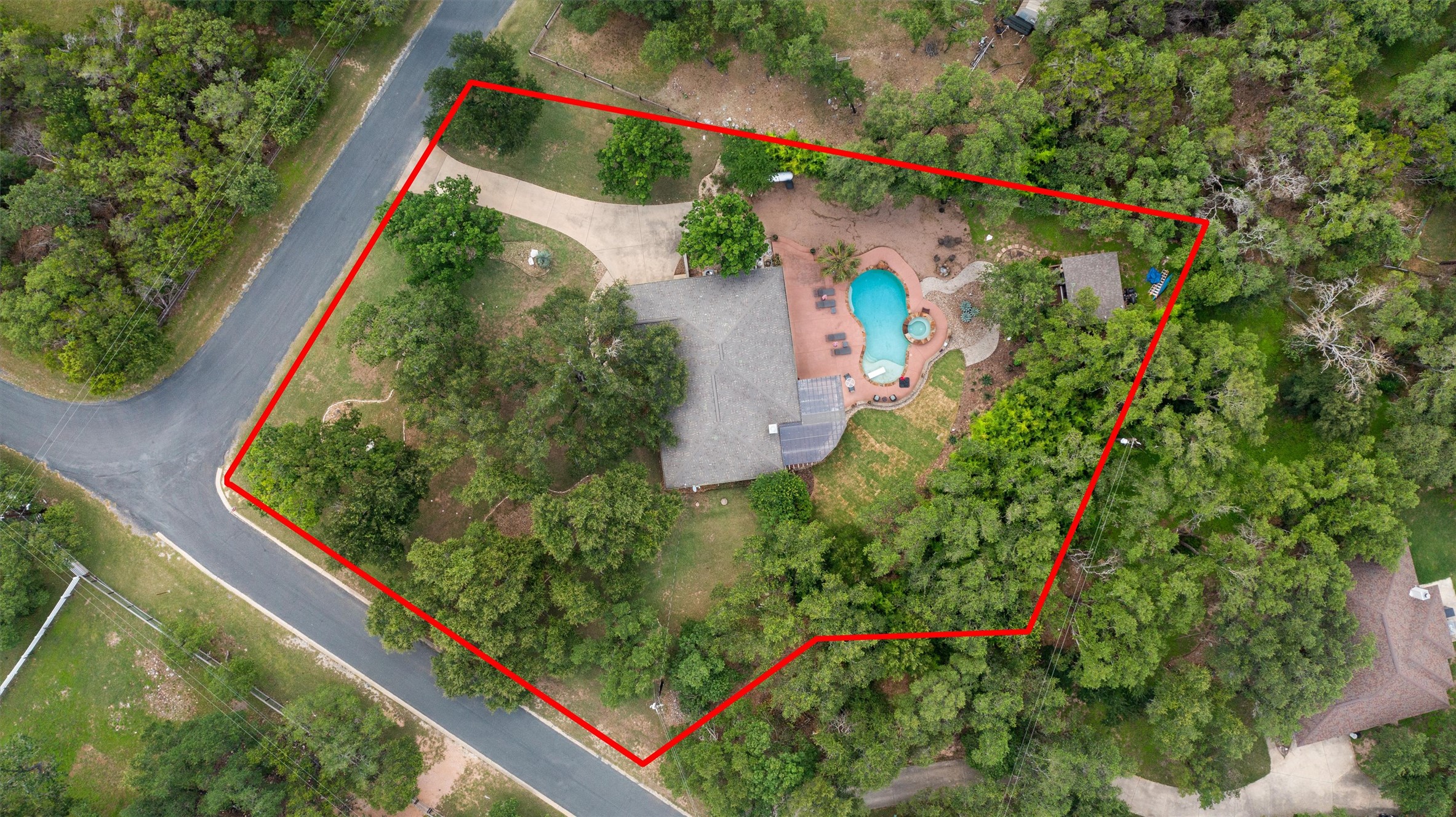 223 East Ridgewood Road Georgetown, TX 78633 - Photo 39 of 40 An aerial perspective reveals a secluded residence surrounded by lush woodlands, complete with a private swimming pool