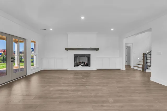a view of an empty room with a fireplace and a window