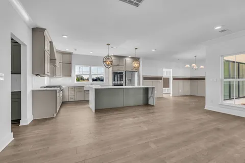 a view of kitchen with kitchen island and stainless steel appliances