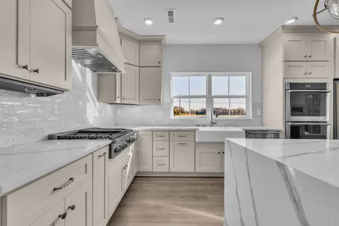 a kitchen with granite countertop cabinets stainless steel appliances and a sink