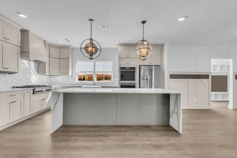 a kitchen with granite countertop white cabinets and white appliances