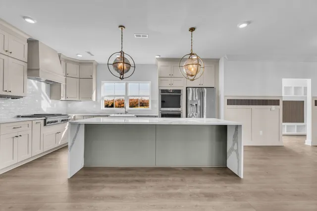 a kitchen with granite countertop white cabinets and white appliances