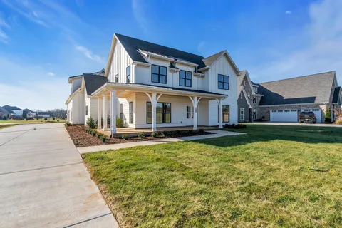 a view of a house with swimming pool and sitting area