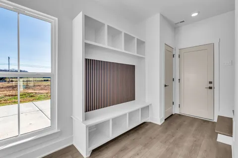 an empty room with a window and wooden floor