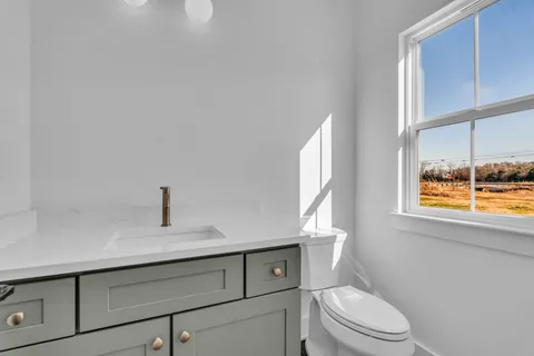 an empty room with wooden floor and window