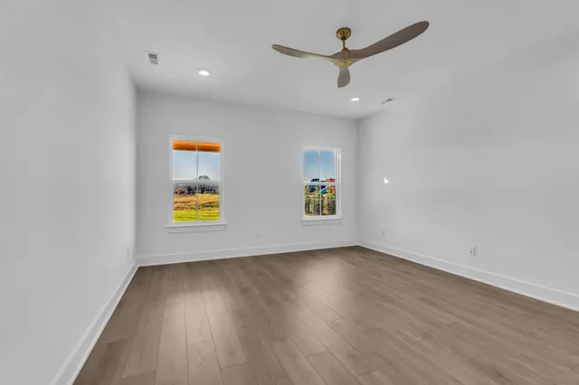 a spacious bathroom with a bathtub sink and mirror