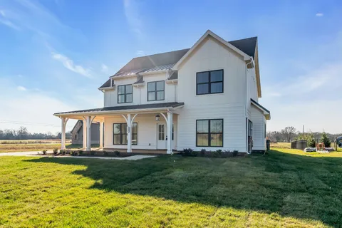 a front view of a house with a yard table and chairs