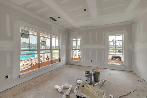 a room with white walls and windows