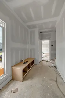 a room with a dresser and a window