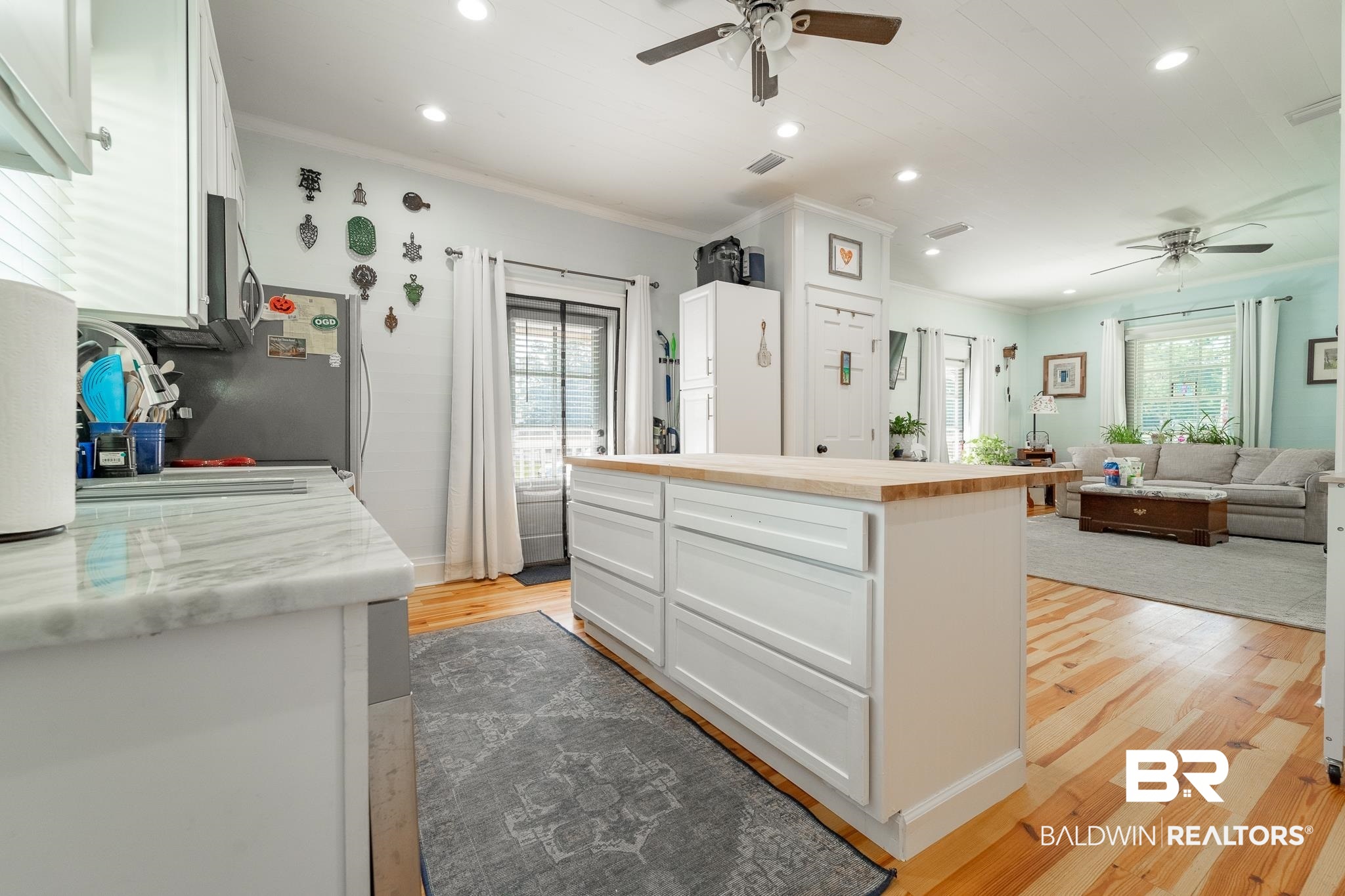950 Texas Street Mobile, AL 36604 - Photo 7 of 17 Kitchen featuring white cabinets, plenty of natural light, light hardwood / wood-style floors, and ceiling fan