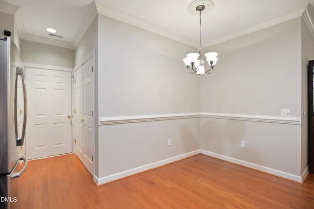 a view of a room with wooden floor