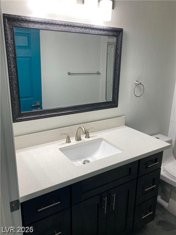 9050 West Warm Springs Road, Unit 1027 Las Vegas, NV 89148 - Photo 23 of 44 A refined bathroom featuring a clean vanity with a pristine white sink and a spacious, decorative mirror.